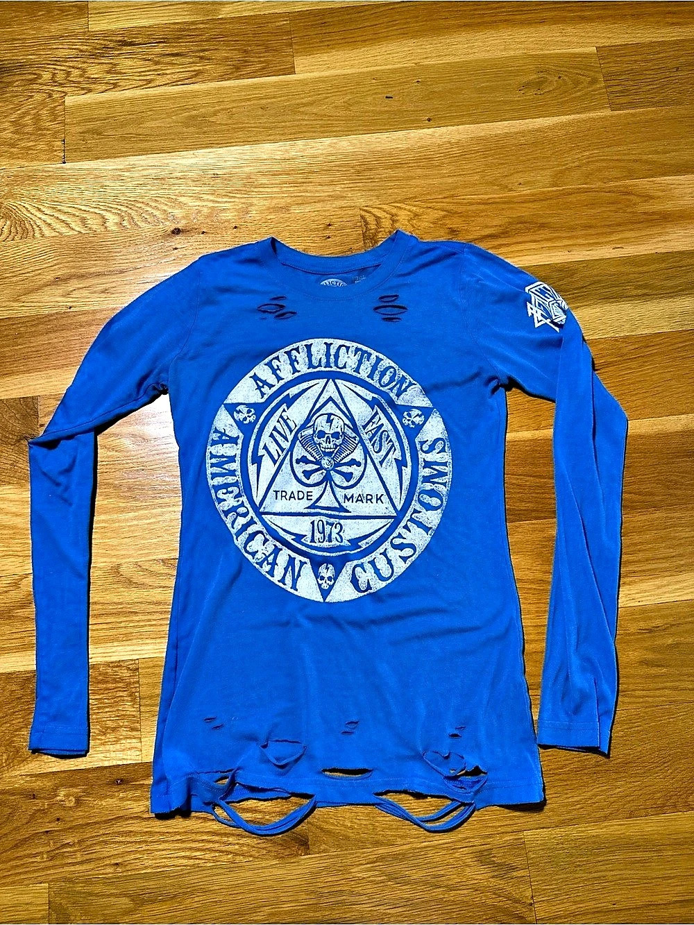 Affliction blue long sleeve shirt with white circular logo featuring skull and t